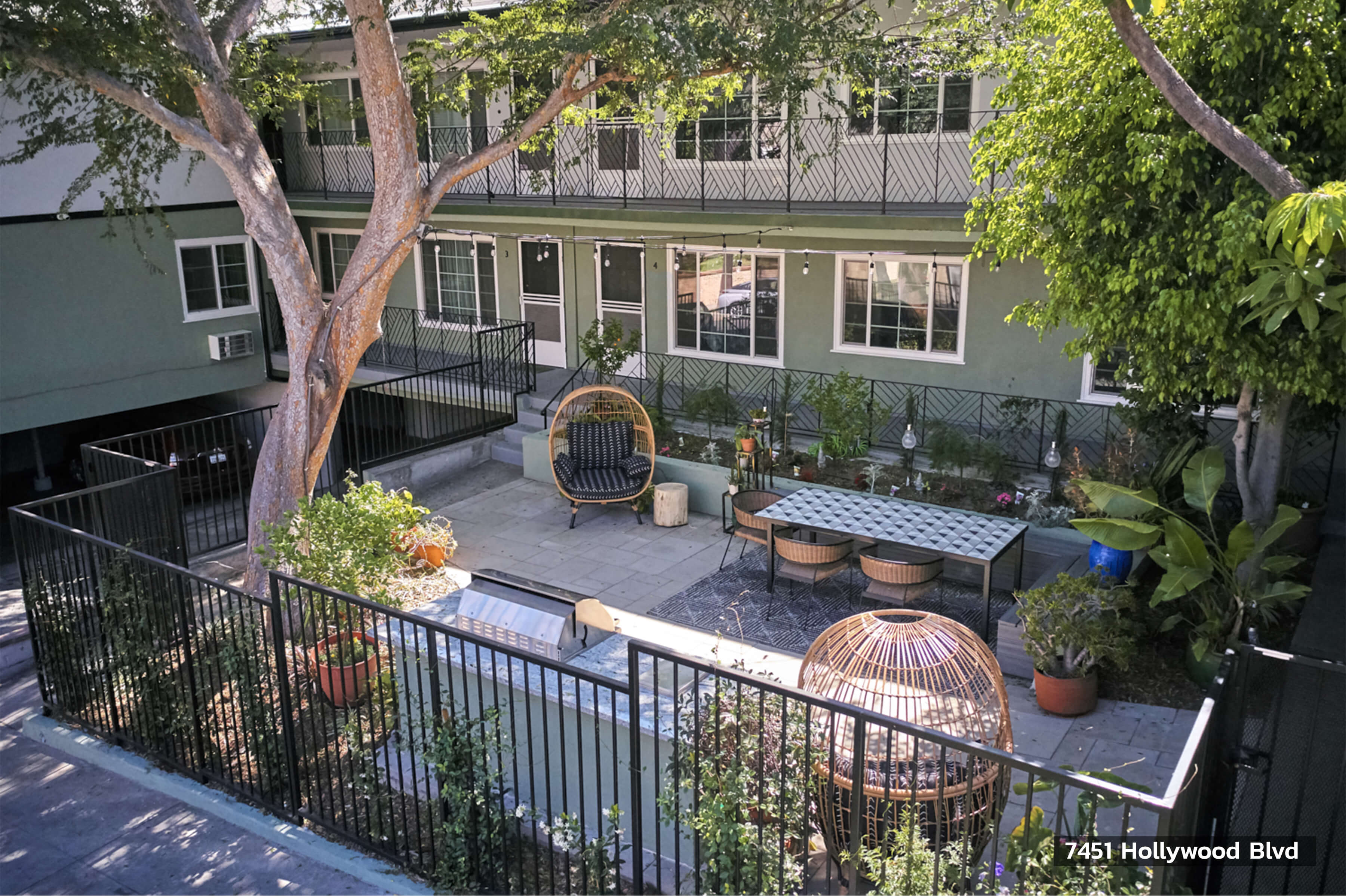 Beautiful green outdoor lounge space with seating and BBQ